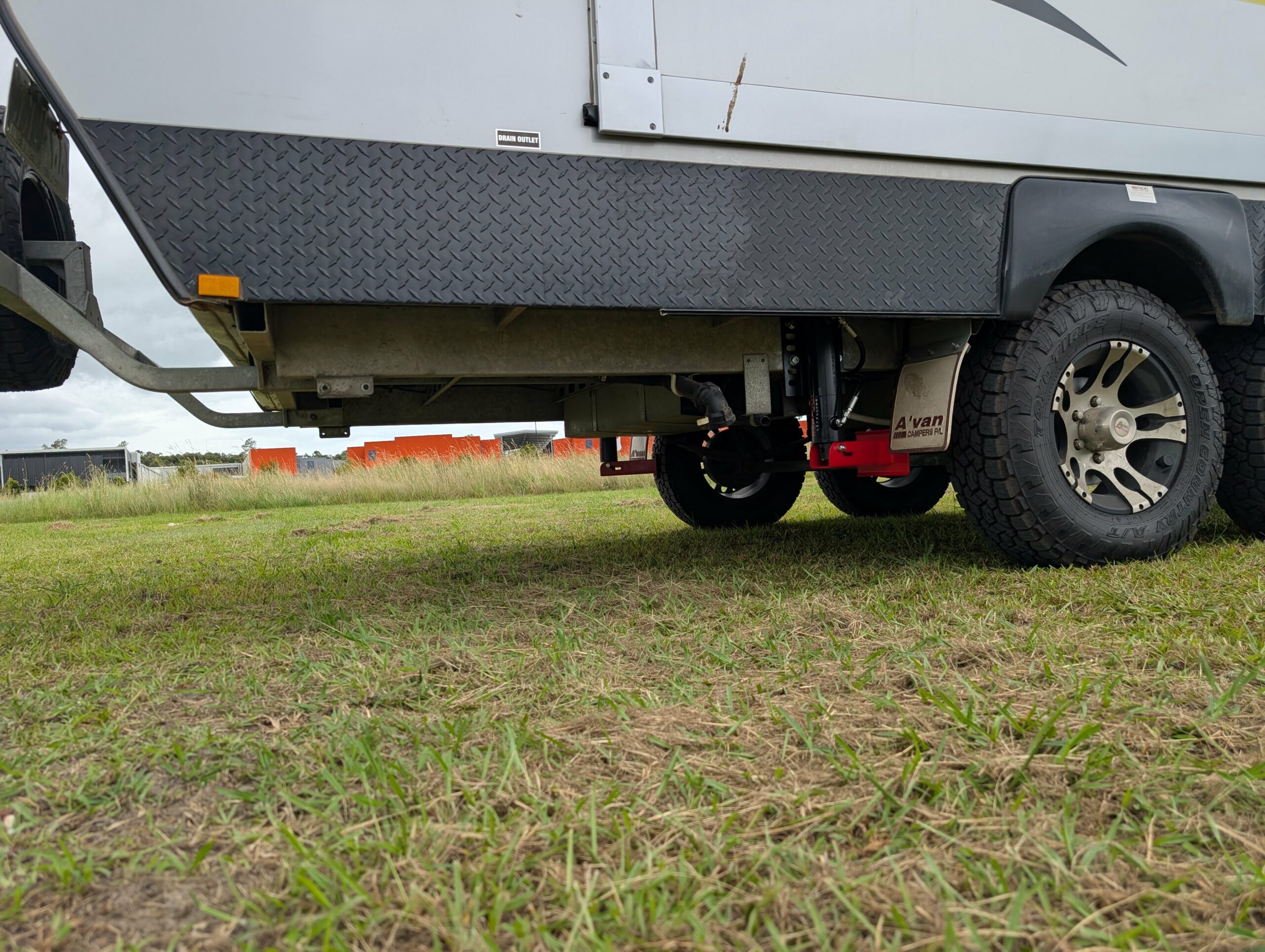 Redfoot flip leg system retracted behind caravan rear wheels