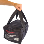 Redfoot Levelling - A person holding a black bag with the word "redfoot" on it, showcasing Redfoot Levelling Camper Levellers and chocks.