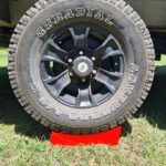 Redfoot Levelling - A Redfoot Levelling Camper Leveller with a tire stand on top of it designed for caravans.