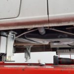 Redfoot Levelling - The underside of a car with a tire under it and the Redfoot Levelling Mercedes Benz 'AutoLift' system.