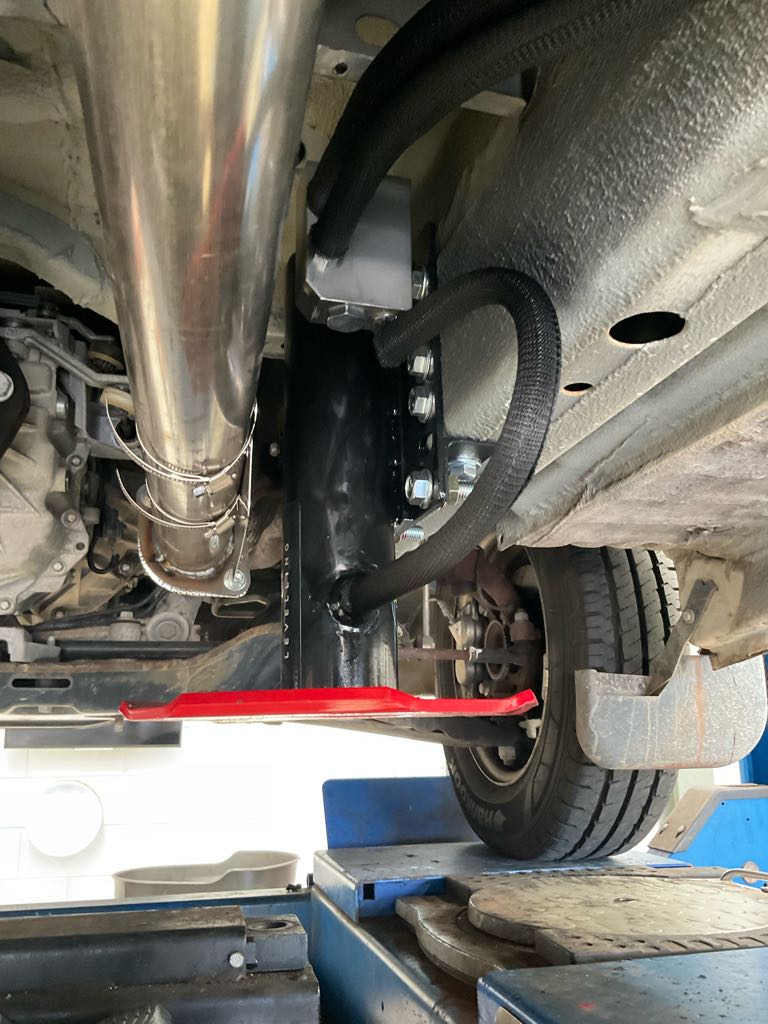 Underside of Ford Transit with hydraulic jack attached